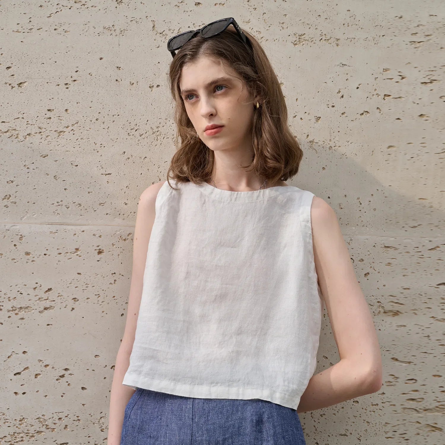 Asymmetric linen crop top for women featuring sleeveless crew neck